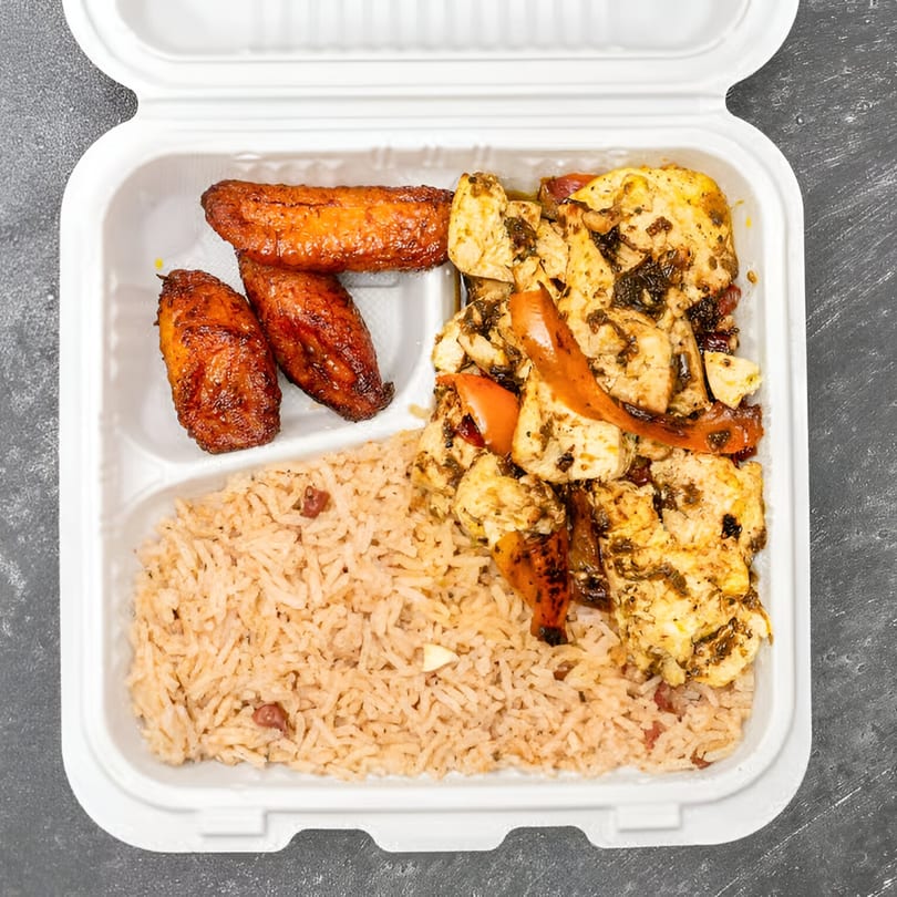 Jamaican Way's jerk chicken with rice and peas, and fried plantains in a takeout container.